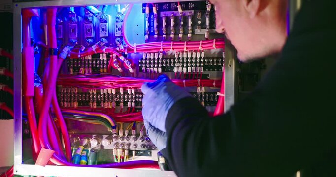 Technician Working on Electrical Panel in Engine Room