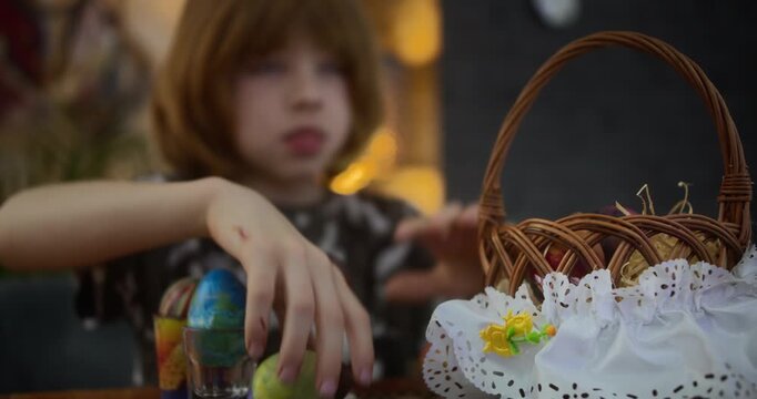 8-Year-Old Boy Placing Easter Eggs into a Basket on Holiday | Holiday Basket in the Foreground, with a Blurred Boy in the Background | T1.2 Lens, 4K, 12-Bit HQ Video