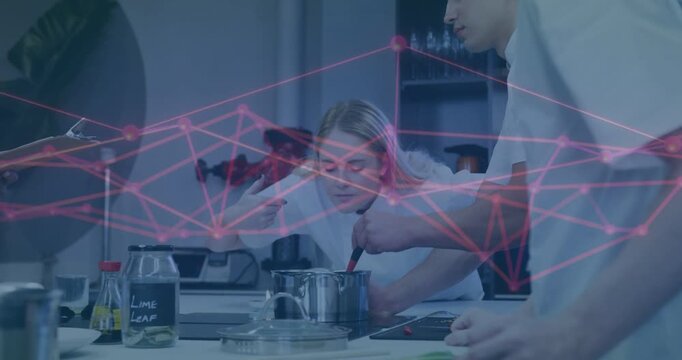 Female chef leaning into pot in kitchen, male chef stirring, checking aroma, magenta overlay moving