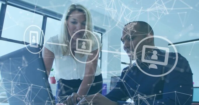 Vertical video: Woman pointing at laptop urging man typing and using cell solving IT issue overlay