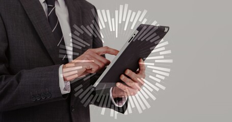 Holding professional in dark-gray suit and striped tie tapping tablet at studio, with radial data © vectorfusionart
