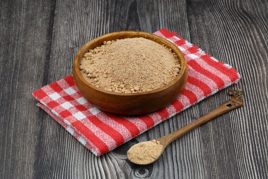 Organic Oleaster Seed Powder in a Rustic Wooden Bowl on a wooden Background for Healthy Living