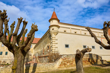 Medieval fortress with stone walls and turret under blue sky © Iurii Gagarin