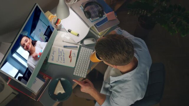 Happy colleagues calling web in evening home top view. Man talking virtual chat