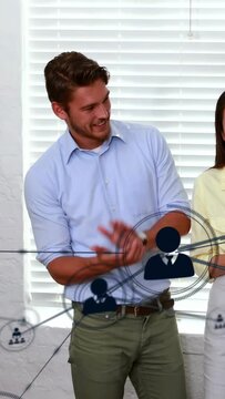 Vertical video: Man leaning and clapping starting network overlay for IT demo icons sweeping across