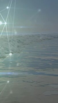 Vertical video: Camera approaching ocean surface, nodes sweeping inward, foam reflecting for tech