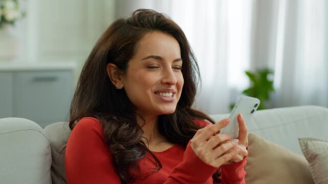 Excited happy Caucasian woman use mobile phone read amazing news winning online amazed business female girl businesswoman client buyer smartphone euphoria emotional positive message at home on couch