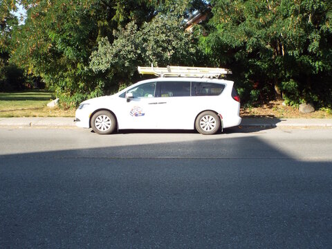Ottawa, Ontario, Canada &ndash; July 25, 2025: A white "Ledcor" service van with ladders on its roof is parked along a residential street in Ottawa, Ontario on Cummings Avenue.
