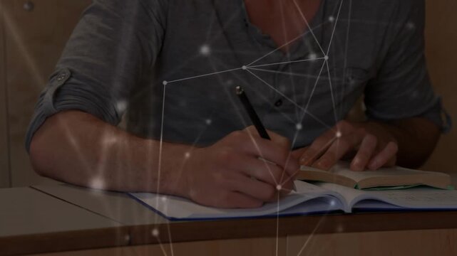 Student reading textbook taking notes with pen in notebook network drifting across pages education