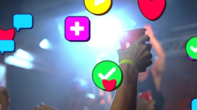 Concert attendee raising red cup, celebrating, causing social icons overlaying crowd and performer