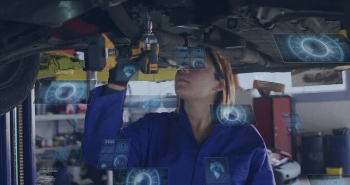 Female auto mechanic engaging tool under car, watching AR gauges guiding bolt torquing for repair