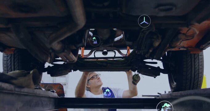 Tech inspecting auto underside as lift rising probing mounts for diagnosis while AR icons updating