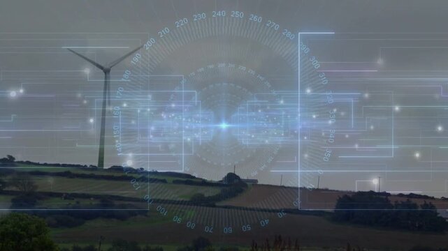 Displaying blue hologram circular interface overlaying rural hillside fields, wind turbine rotating