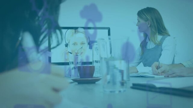 Team taking notes in business meeting remote peer speaking causing purple icons over table to plan