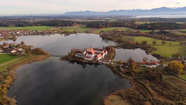 Tranquil aerial scene of Lake Seeon and monastery island in autumn, Chiemgau region, Bavaria, Germany. Luftaufnahme des Kloster Seeon in Seeon-Seebruck, Oberbayern, Deutschland. Landkreis Traunstein