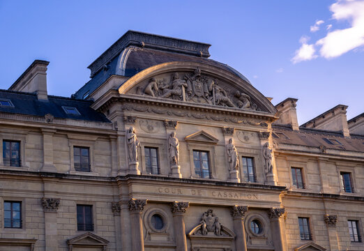 Paris, France - 08 04 2025: Close up of the Cour de Cassation building at the Palais de Justice. Detailed view of the neoclassical facade with sculptures and stone carvings during golden hour.