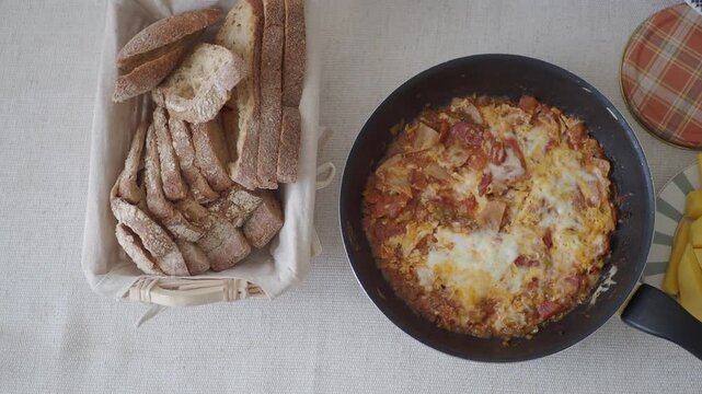 Breakfast top view with food on table delicious shakshuka bread fruit and grapes dynamic footage.