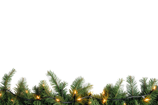 Christmas garland with evergreen branches and glowing string lights forming a festive holiday border, transparent background