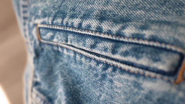Close up of blue denim pocket and textured fabric