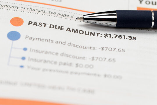 Medical billing statement showing a past due amount, with a pen placed on top. Highlights financial stress, healthcare costs, insurance adjustments, and overdue payments.