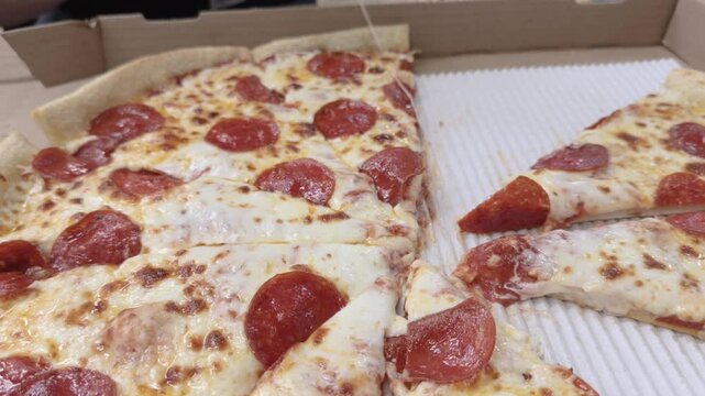 Grabbing slices of pizza from a delivery box 4k