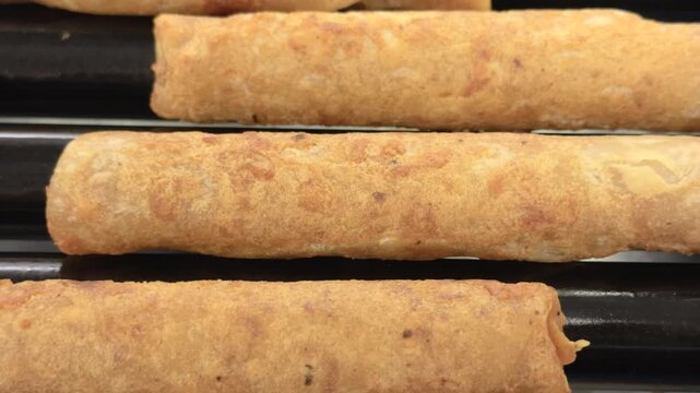Dried out food item on grill roller of gas station 4k
