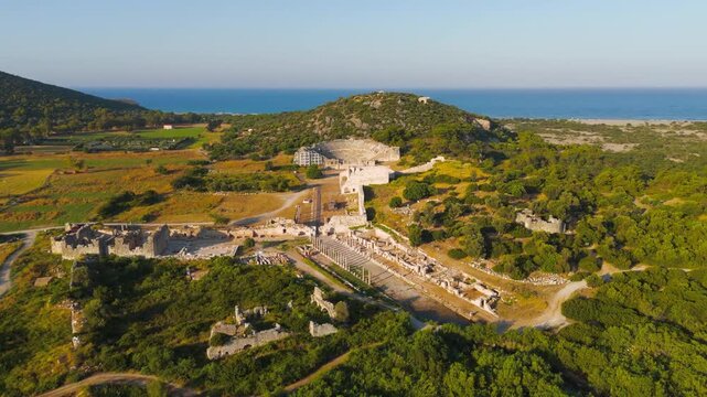 Gelemis, Turkey. Monumental Colonnaded Street leading to Agora in Patara, impressive urban planning of ancient Lycian city. Aerial View, MasterShots, Circle (Far)