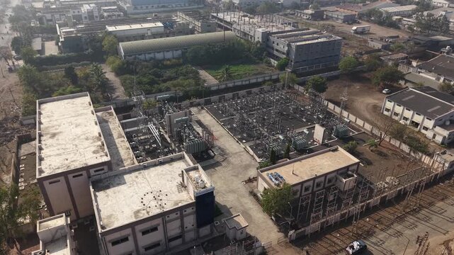Close Aerial Shot of Electrical Substation Transformers and Switchgear in Industrial Complex.