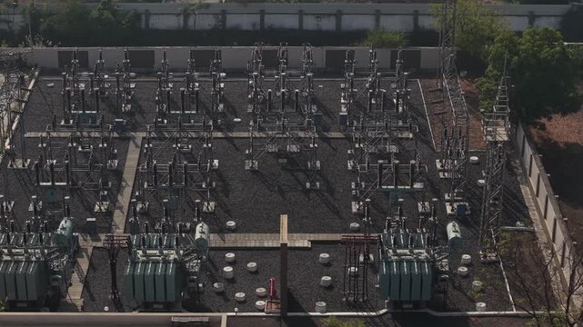 Close Detail of Three Phase Power Transformers in an Industrial Electrical Grid Station.
