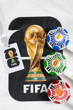 ZHONGSHAN China-April 3 2026: T shirt with the 2026 FIFA World Cup trophy logo and portable fans and a World Cup trophy card at vertical composition.