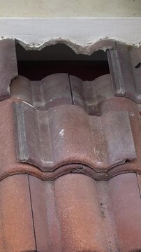 Damaged old roof tile in need of repair.
