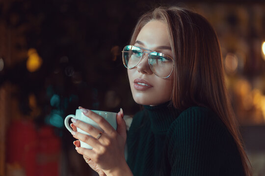 Woman with the Cup of Hot Beverage. Warm Colors Toned