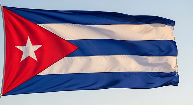 Cuban flag waving in daylight national symbol on a blue sky background