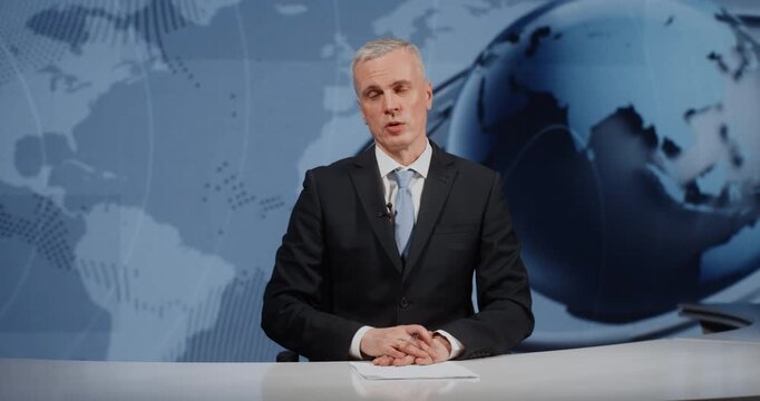 Serious News Presenter Finishing Live Report in Digital TV Studio. Mature Man Journalist Sitting, Looking at Camera and Talking. Concept of Television Industry, Daily News and Final Closing Remarks.