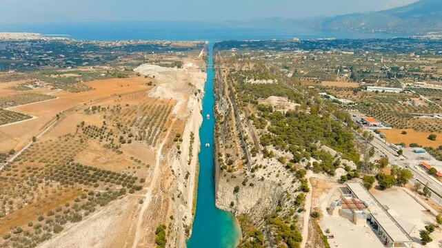Corinth Canal, Greece. The Corinth Canal is a sluiceless shipping canal in Greece, connecting the Saronic Gulf of the Aegean and the Gulf of Corinth of the Ionian Sea. Drone footage, Departure of the
