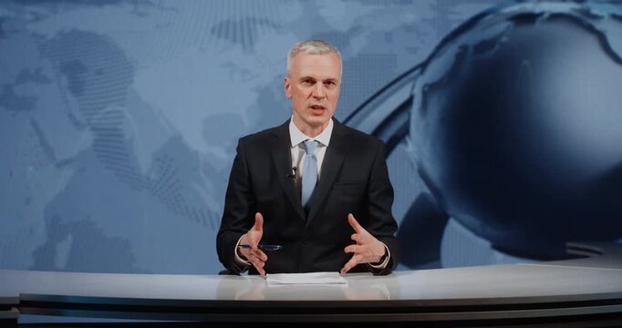 Professional Mature Male News Anchor Finalizing Daily Digest and Bids Farewell to Audience in Modern Television Studio. Concept of News Program and Journalism, Professional Broadcast Wrap Up.