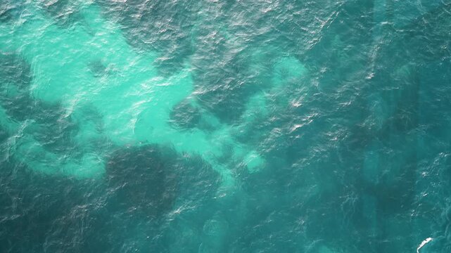 수정처럼 투명하고 맑은 에메랄드빛 바다 수면의 고해상도 항공 텍스처 (High-resolution aerial texture of crystal clear emerald ocean water surface)