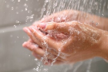 Fototapeta premium A close-up of hands washing with running water.