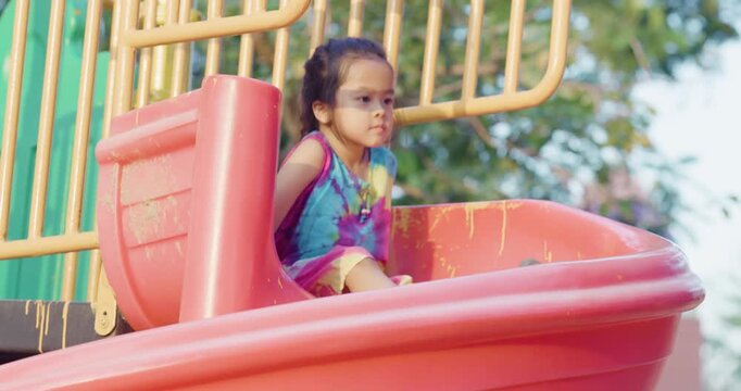 Little kindergarten girl enjoy climb on slider outdoor playground city park active learnning
