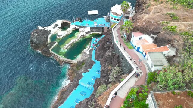 Aerial summer view of Doca do Cavacas in Madeira, capturing turquoise waters, moored boats, and vibrant coastal scenery