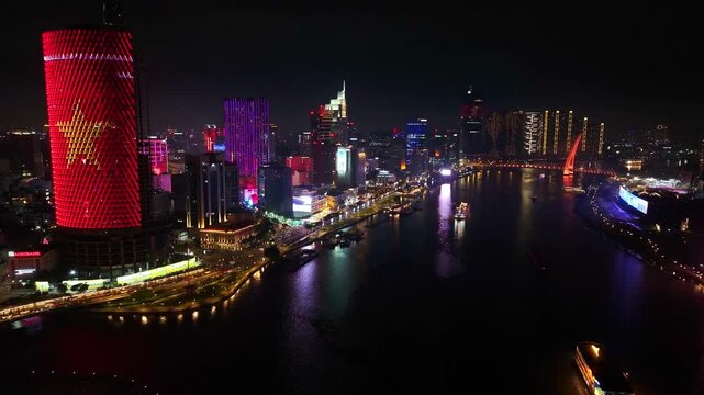Aerial drone view of Ton Duc Thang street, district 1 Ho Chi Minh City SaiGon at night with Saigon river, Ba Son bridge and Vietnam flag building