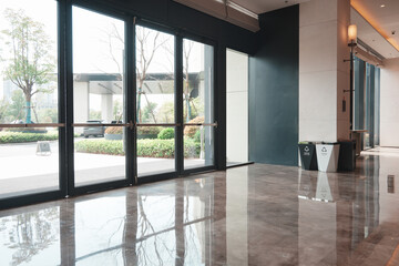 Fototapeta premium Modern interior corridor with glass doors and polished marble flooring reflecting natural light