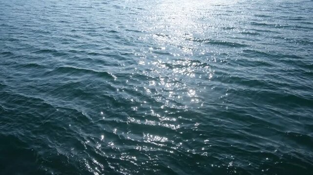 Sunlight Reflecting on Water Surface with Gentle Waves