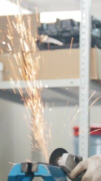 Mechanic at work - circular saw sparkles when worker grinding metal detail hamstrung automobile repairin