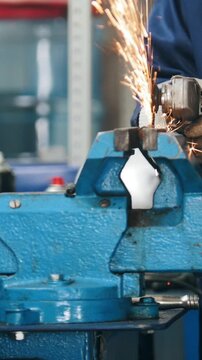 Circular saw sparkles -mechanic grinding metal detail hamstrung automobile repairing, close up view