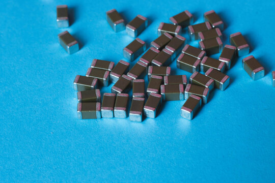 Surface mount ceramic capacitors on blue background