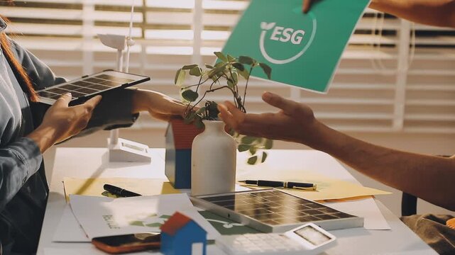 Business executives collaborating on environmental sustainability strategy utilizing renewable energy solutions to achieve net zero targets in corporate meeting.