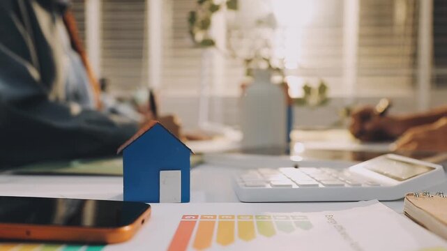 Business executives collaborating on environmental sustainability strategy utilizing renewable energy solutions to achieve net zero targets in corporate meeting.