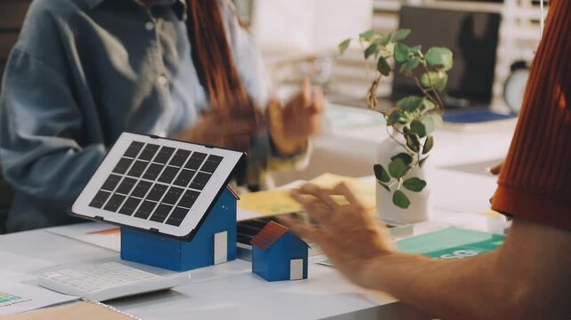 Business executives collaborating on environmental sustainability strategy utilizing renewable energy solutions to achieve net zero targets in corporate meeting.