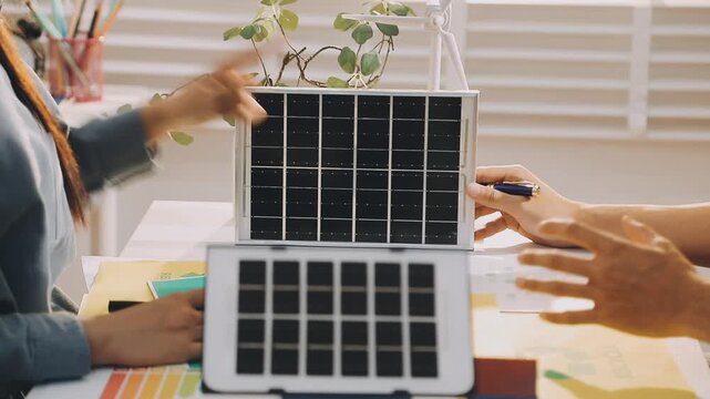 Business executives collaborating on environmental sustainability strategy utilizing renewable energy solutions to achieve net zero targets in corporate meeting.